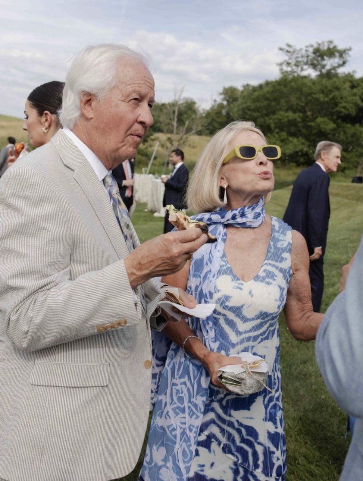 Wedding guest in a blue patterned dress