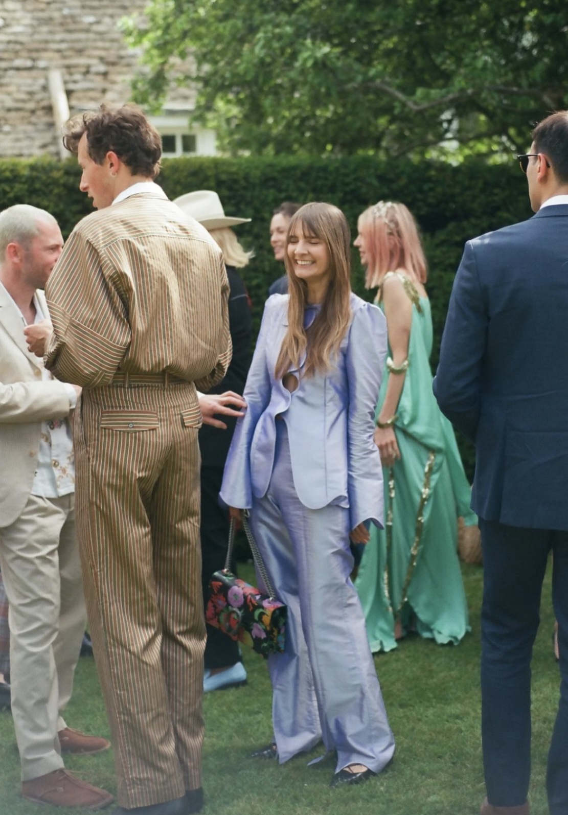 Guests in tailored suits and colourful outfits