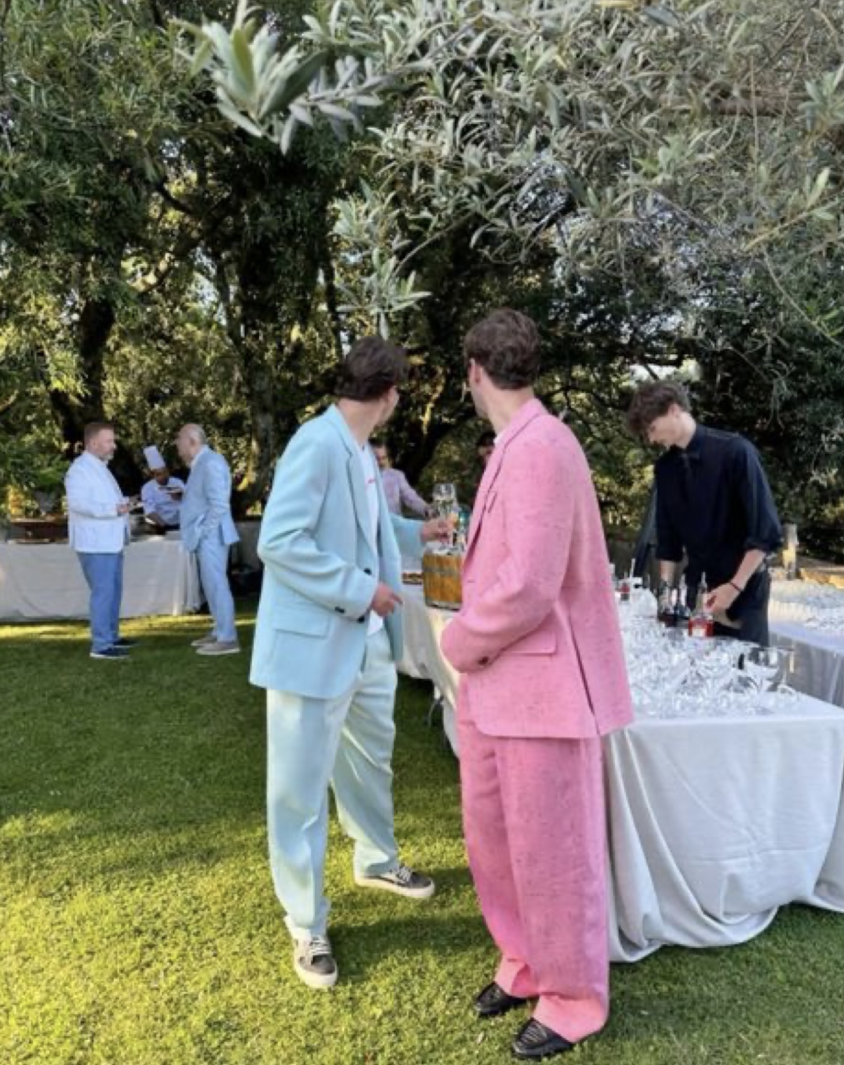Guests in colourful suits outdoors